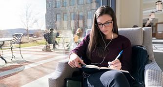Photo of student studying in library