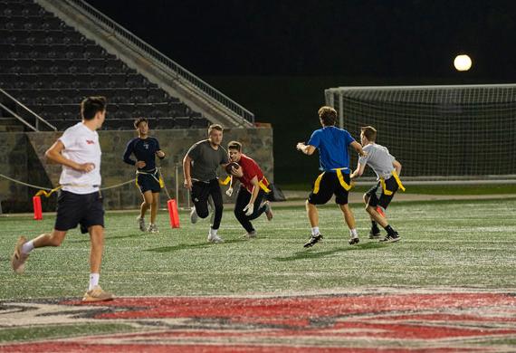 An image of students competing in intramural flag football at Tenney Stadium.