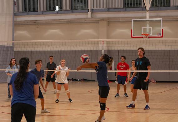 An image of students competing in intramural volleyball.