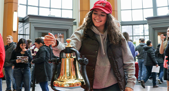 Image of student ringing the deposit bell