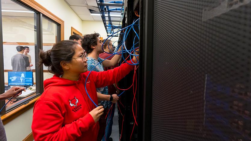 Image of Students in the School of Computer Science and Mathematics in the Networking Lab at the Hancock Center.